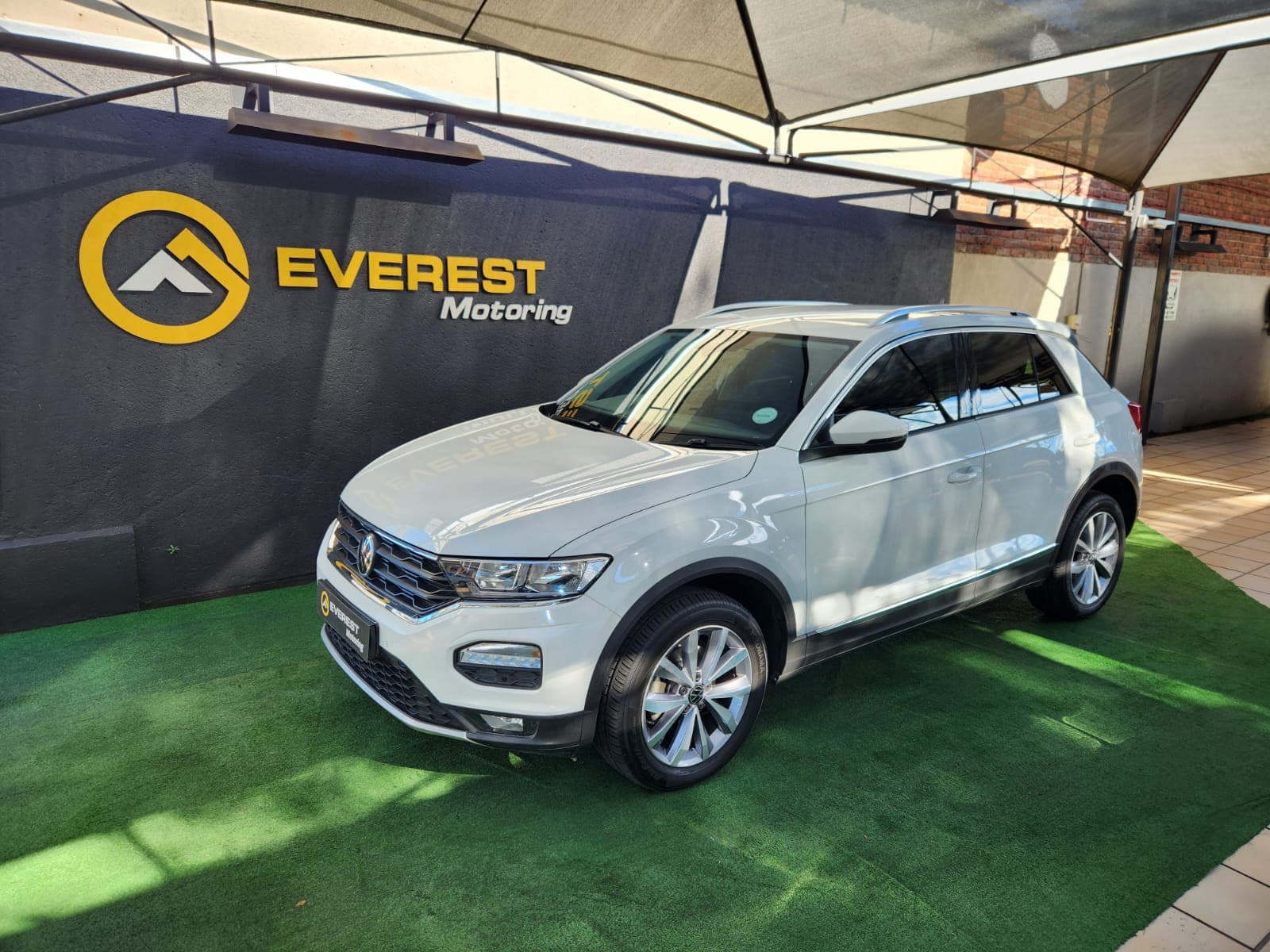 White 2021 Volkswagen T-Roc 1.4 TSI Design Auto, front left three-quarter exterior view at dealership.