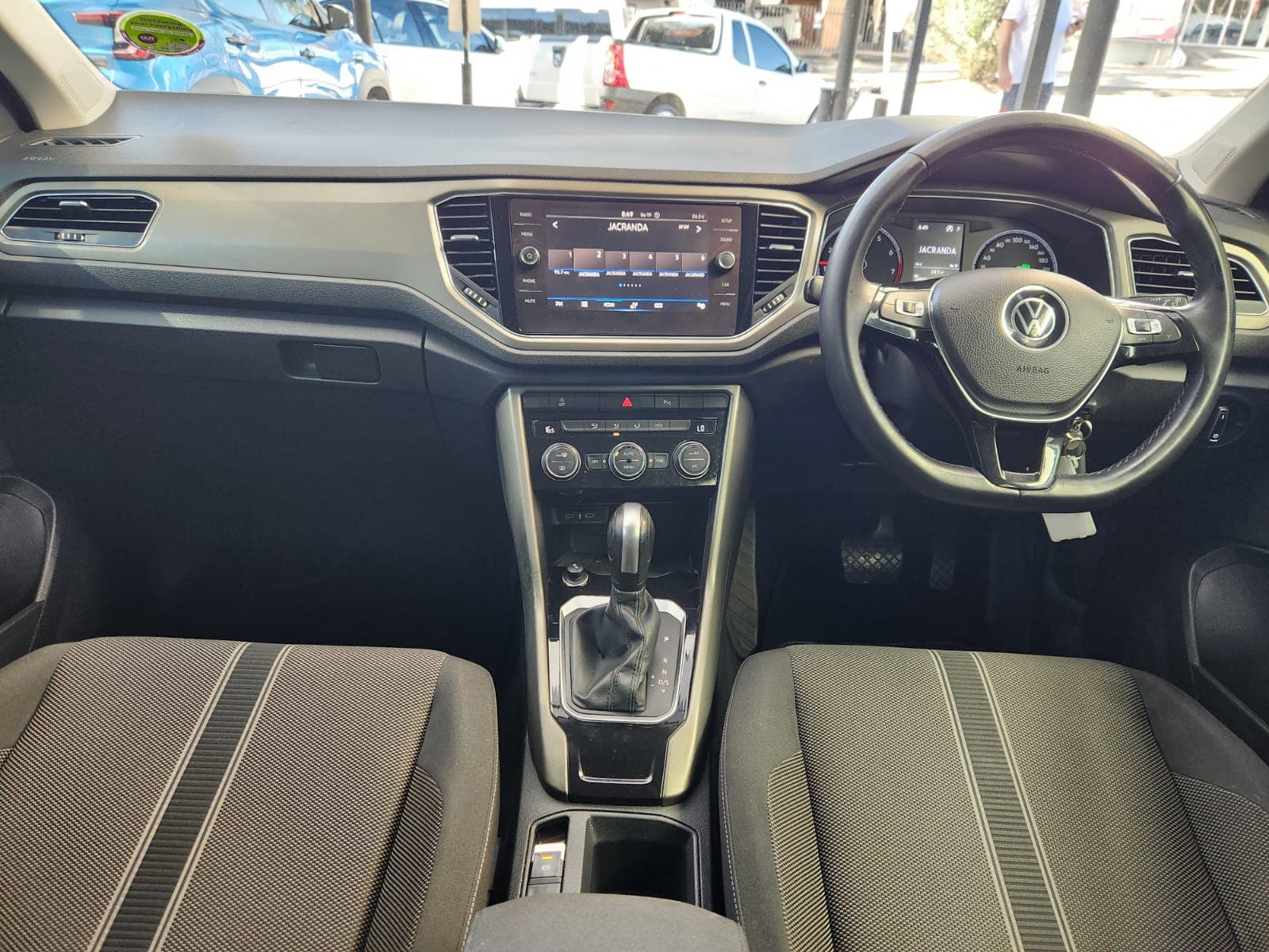 Interior view of the dashboard and centre console in a 2021 Volkswagen T-Roc 1.4 TSI Design Auto.
