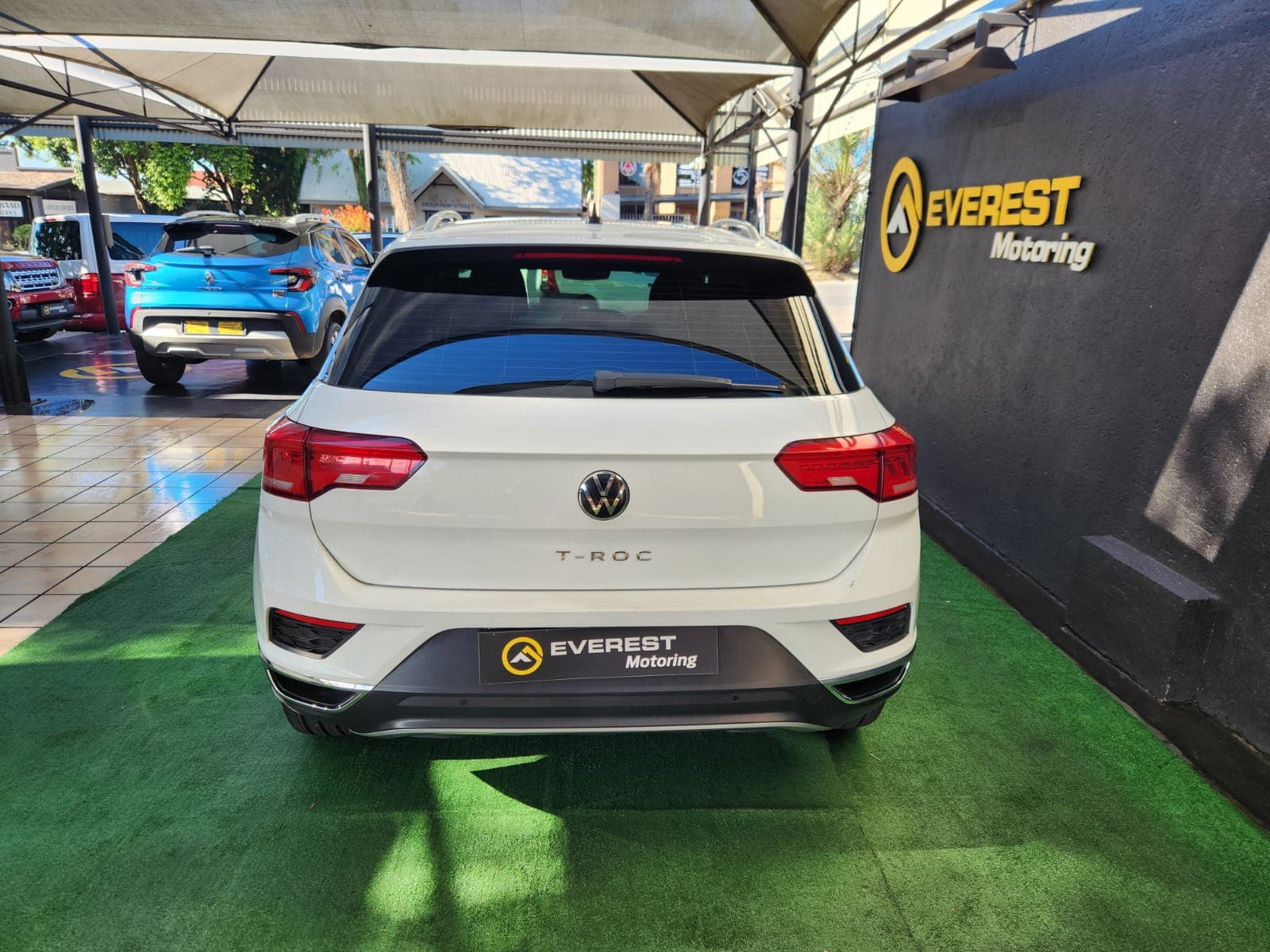 White 2021 Volkswagen T-Roc 1.4 TSI Design Auto, full driver's side exterior profile view on display.