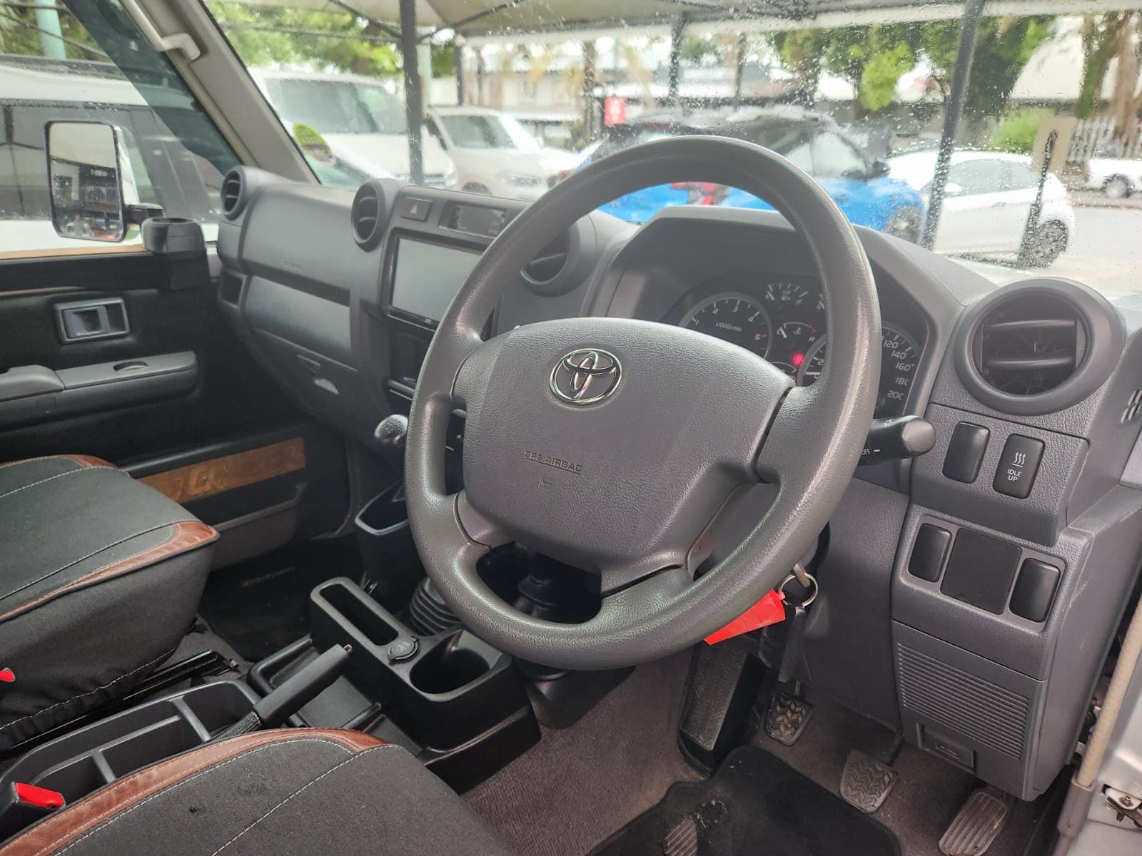 Interior view of the 2019 Toyota Land Cruiser 79 4.5 D Single-Cab dashboard, showing steering wheel and instrument cluster.