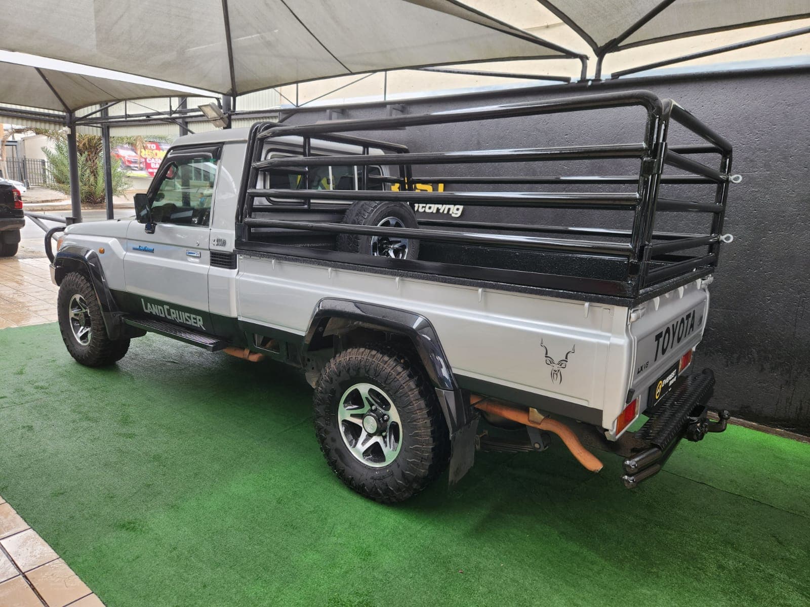 Silver 2019 Toyota Land Cruiser 79 4.5 D Single-Cab, rear three-quarter view, showcasing roll bar and tow bar.