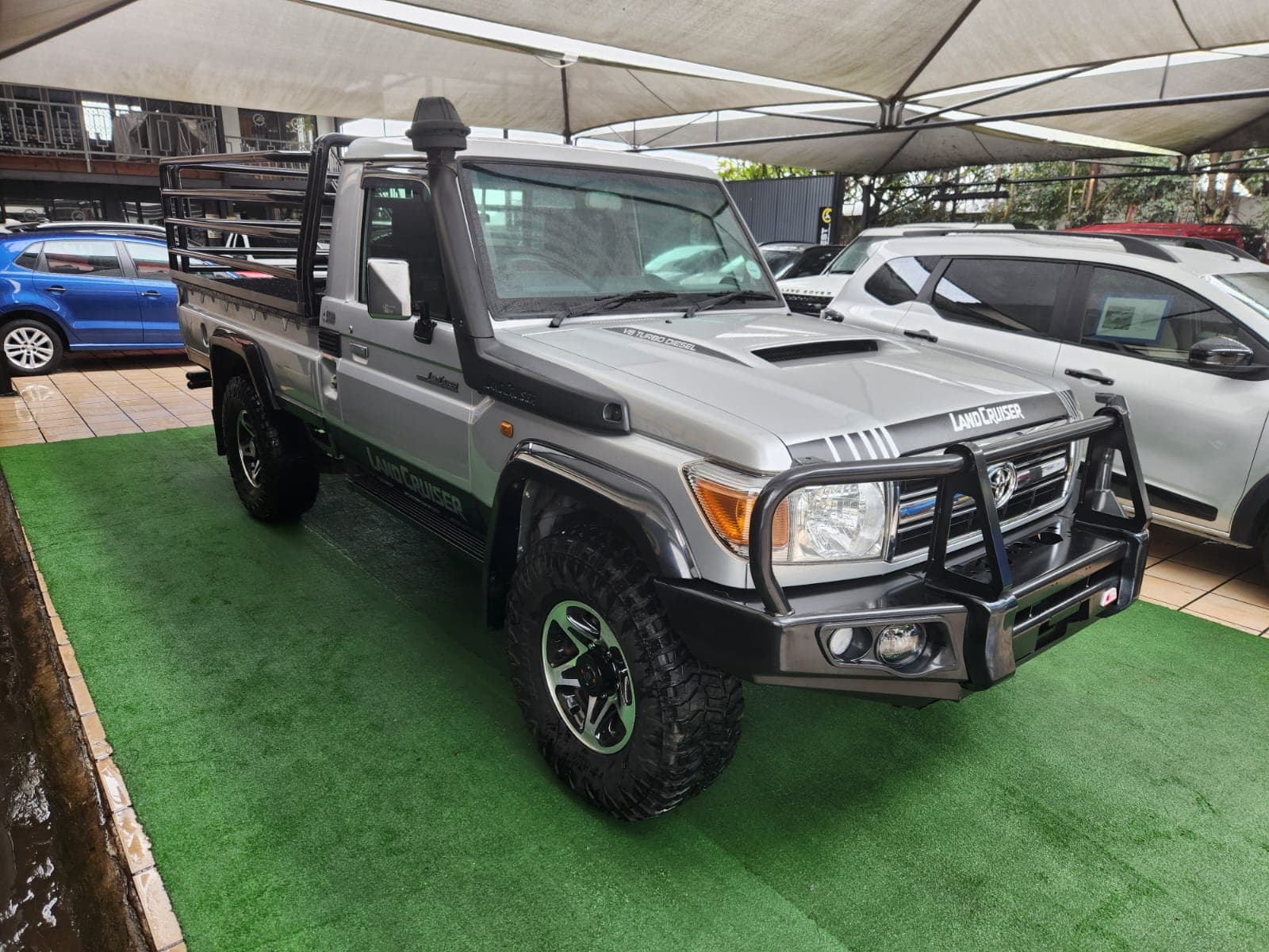Silver 2019 Toyota Land Cruiser 79 4.5 D Single-Cab, front three-quarter view from the other side, with snorkel.