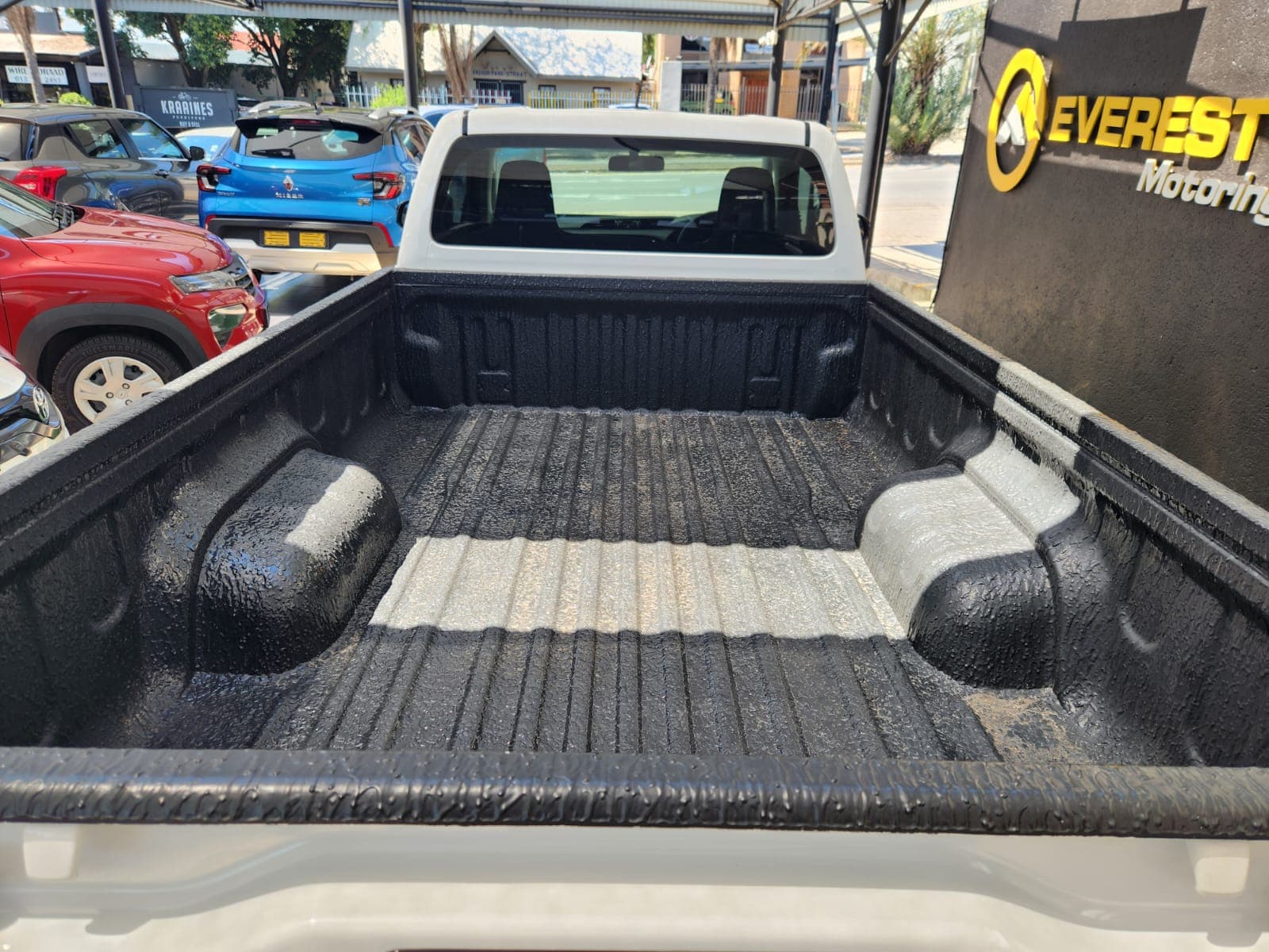 Rear view of the 2025 Toyota Hilux 2.4 GD Single-Cab load bay, showing durable black bed liner texture.
